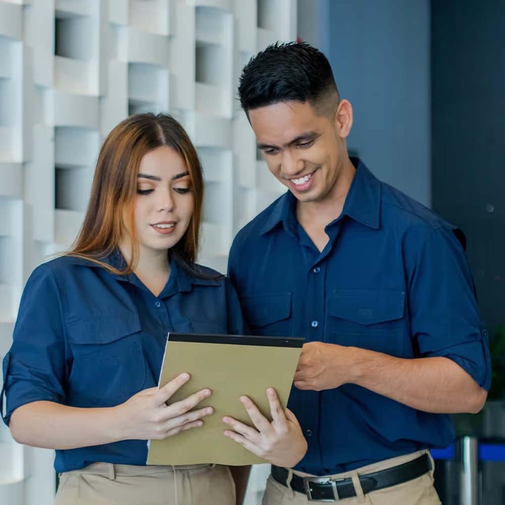 Two Dust Busters team members reviewing a service plan